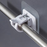 Close-up of wall-mounted adhesive towel rod holder with hanging towels