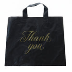 A black plastic 'Thank You' bag with gold script is displayed flat against a plain white background.