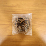Spiral cable protector sleeve in use, neatly wrapping a cable on a desk.