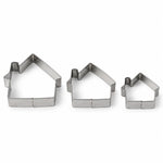 Three silver house-shaped cookie cutters of varying sizes arranged on a plain white background.