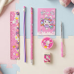 A pink rabbit-themed stationery set arranged neatly on a light blue and pink foam mat, viewed from above.