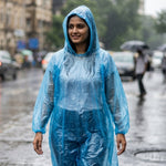 A folded blue plastic rain poncho is sealed in clear packaging with a white label featuring Chinese characters and a cartoon.