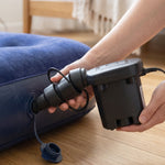 A black electric air pump with a tapered nozzle is shown in detail against a plain white background.