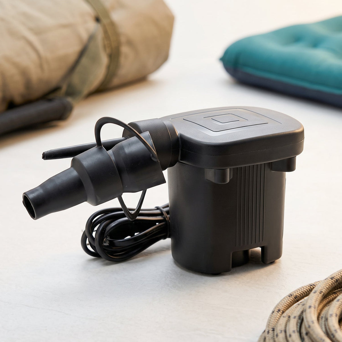 A black electric air pump with a multi-sized nozzle is shown with its dimensions, 7 cm wide and 10 cm high.