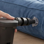 A single black multi-sized nozzle with a small loop attachment is displayed on a grey patterned surface.
