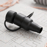 The black electric air pump, its detachable nozzle, and its product box are arranged on a wooden table.