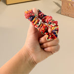 Variety of colorful fabric hair scrunchies in different prints