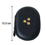 Two closed black oval hard shell cases are side-by-side on a wooden surface; one has a white