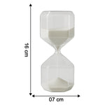 Close-up of glass timer with fine white sand flowing inside for precise visual countdown