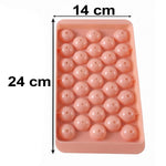 A pink plastic ice ball tray with dimensions 24 cm by 14 cm marked on a white background.