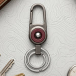 Durable metal key holder with dual rings and locking clip attached to a backpack