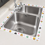 The cartoon-printed sealing tape is applied around the perimeter of a double stainless steel kitchen sink.