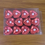 Heart shaped decorative LED tea light candles glowing softly at night