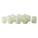 A group of twelve unlit cream ribbed LED candles with black wicks are scattered on a white background.