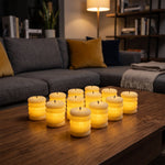 Twelve glowing cream ribbed LED candles illuminate a dark wooden coffee table in a cozy living room.
