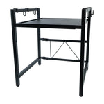 Black metal microwave oven rack with a single shelf and hanging hooks, viewed from an angle on a white background.