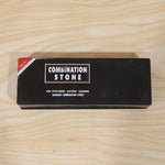 Black cardboard box with red and white text for "Combination Stone" on a light wooden surface.