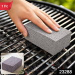 A hand holding a gray cleaning block, scrubbing a dirty metal grill grate, with a small inset showing the block alone.