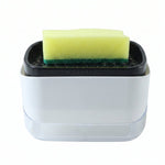 A white and black soap dispenser with a yellow sponge on top is shown against a white background.