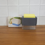 Neatly arranged kitchen sink organizer with soap and sponge