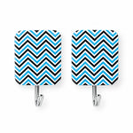 Two identical rectangular adhesive hooks with a blue and black chevron pattern are shown on a plain white background.