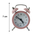 Pink twin bell alarm clock with a black arrow indicating its height of 7 cm, on a white background.