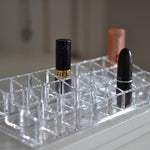 Close-up of the acrylic lipstick holder, showcasing the clarity and design of the 24 organized sections.