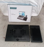 Lifestyle shot of the foldable laptop stand in use with a laptop.