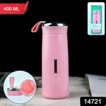 A pink vacuum flask with its lid and glass interior separated, next to its packaging on a black background.