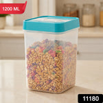 A clear plastic food storage container with a teal lid, filled with colorful cereal, has a red '1200 ML' label and a black