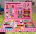 A pink art kit, brimming with diverse art supplies, rests on a textured light green surface.