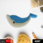 The blue and white dolphin sponge is centered on a white surface with bath items, including a "Made in China" label.