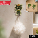 A green cartoon wolf hook holds a white bath pouf on a tiled bathroom wall, with a '2 Pc Mix Design' label.