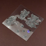 A clear rubber stamp sheet with various nature-themed designs is shown on a brown surface.