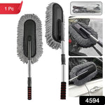 Hand using the soft Car Dust Brush to meticulously clean a car's dashboard without scratching surfaces.