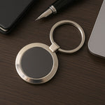 Durable round metal keychain with strong alloy build and black center.