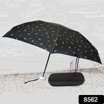 An open black umbrella with gold musical notes stands beside its closed black case on a sketched outdoor scene.