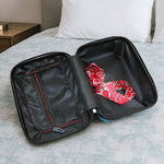 Side view of suitcase showing handle and wheels from the set