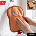 A person's hands gently patting a brown cartoon bread slice towel hanging above a sink,