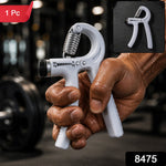 A person's hand holds a white adjustable grip strength trainer with a metal spring in a gym setting, with a small inset