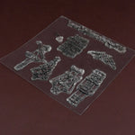 A close-up of the clear silicone stamp sheet, showcasing the detailed designs on a dark brown surface.